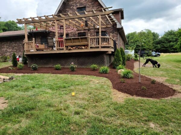 view of back deck with landscape bed installation