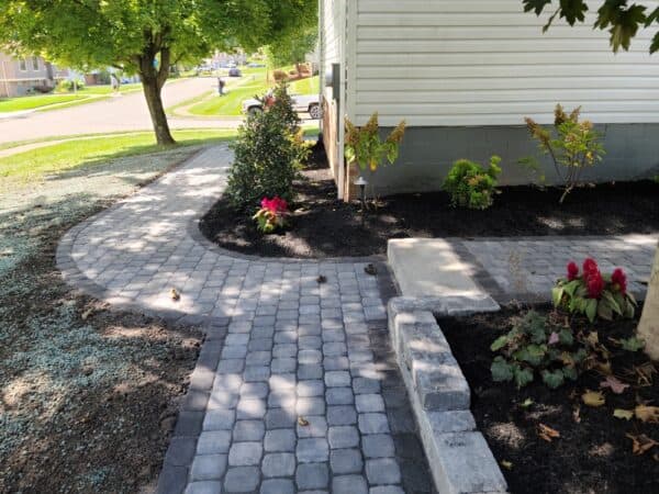 paver sidewalk with a stone step
