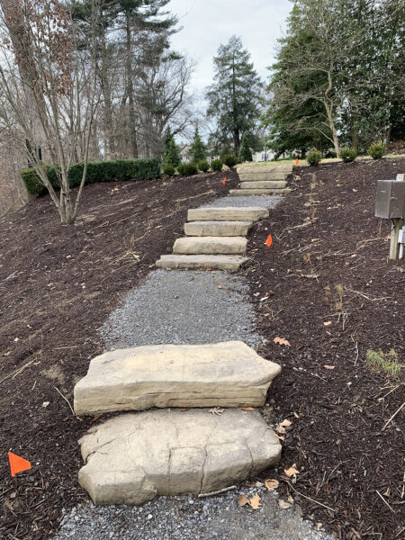 natural stone steps with a gravel landing