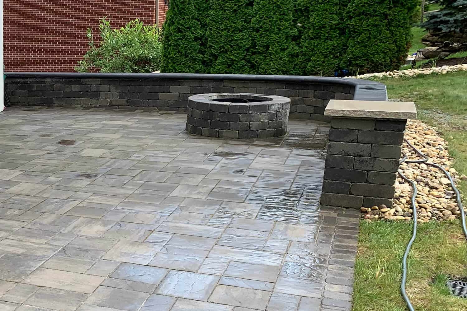 stone patio with fire ring and wall