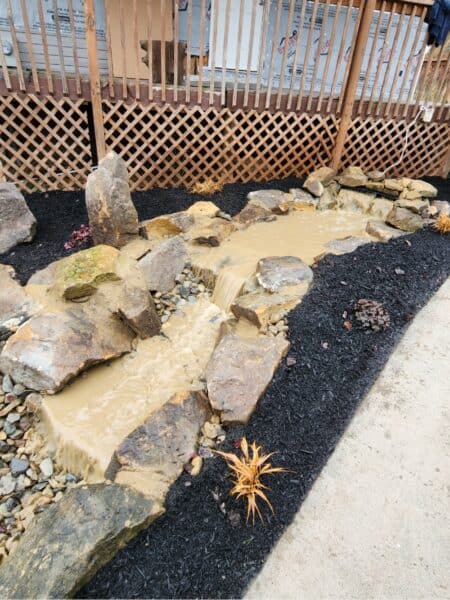 water feature in landscape bed